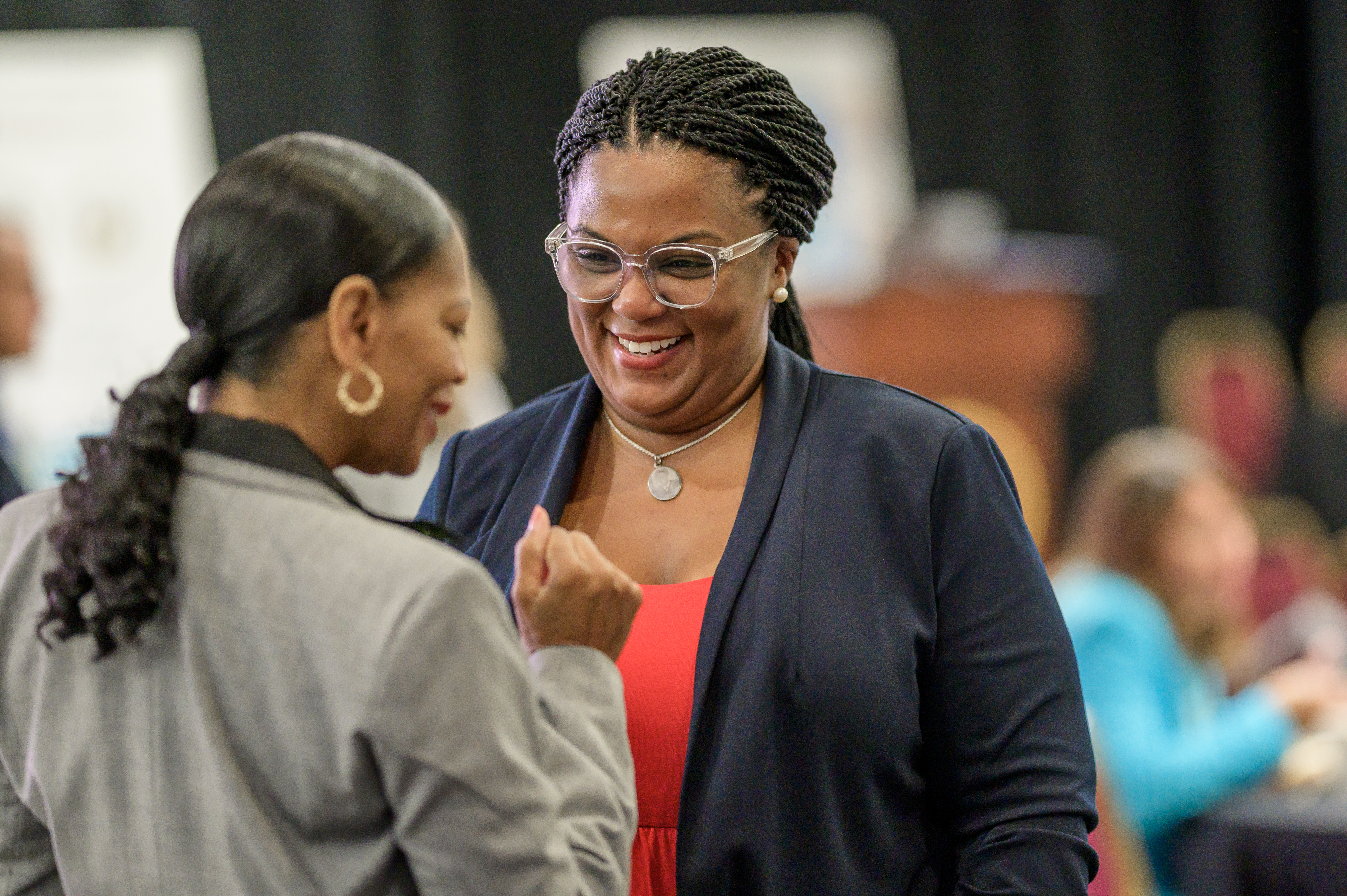 Two women are having a conversation at the 2024 Delaware Healthcare Workforce Summit.