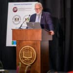 Tim Gibbs speaking at the podium during the 2024 Delaware Healthcare Workforce Summit.