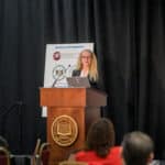 Rebecca Walker speaking at the podium during the 2024 Delaware Healthcare Workforce Summit.