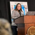 Nichole Moxley speaking at the podium during the 2024 Delaware Healthcare Workforce Summit.