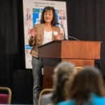 Tabassum Salam speaking at the podium during the 2024 Delaware Healthcare Workforce Summit.