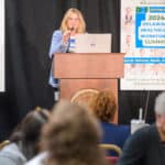 Ann Painter speaking at the podium during the 2024 Delaware Healthcare Workforce Summit.