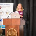 Kate Smith speaking at the podium during the 2024 Delaware Healthcare Workforce Summit.