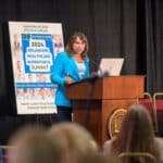 Bernadette Mazurek Melnyk speaking at the podium during the 2024 Delaware Healthcare Workforce Summit.